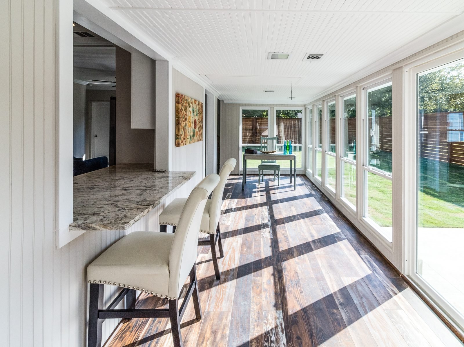 Finished sunroom addition with full-height glass